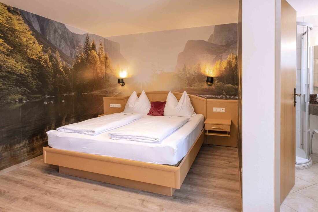 Hotelzimmer mit Doppelbett und schönem Wandbild