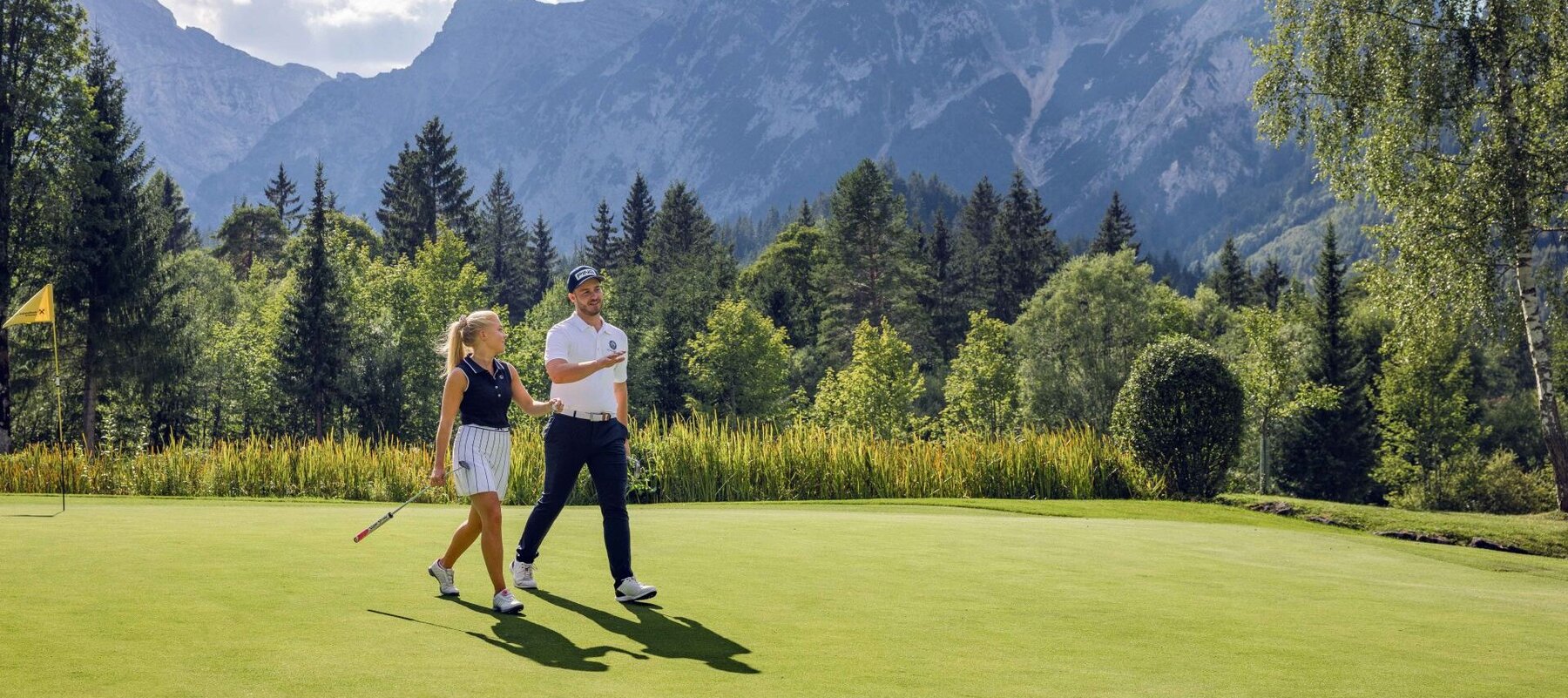 Mann und Frau gehen am Golfplatz